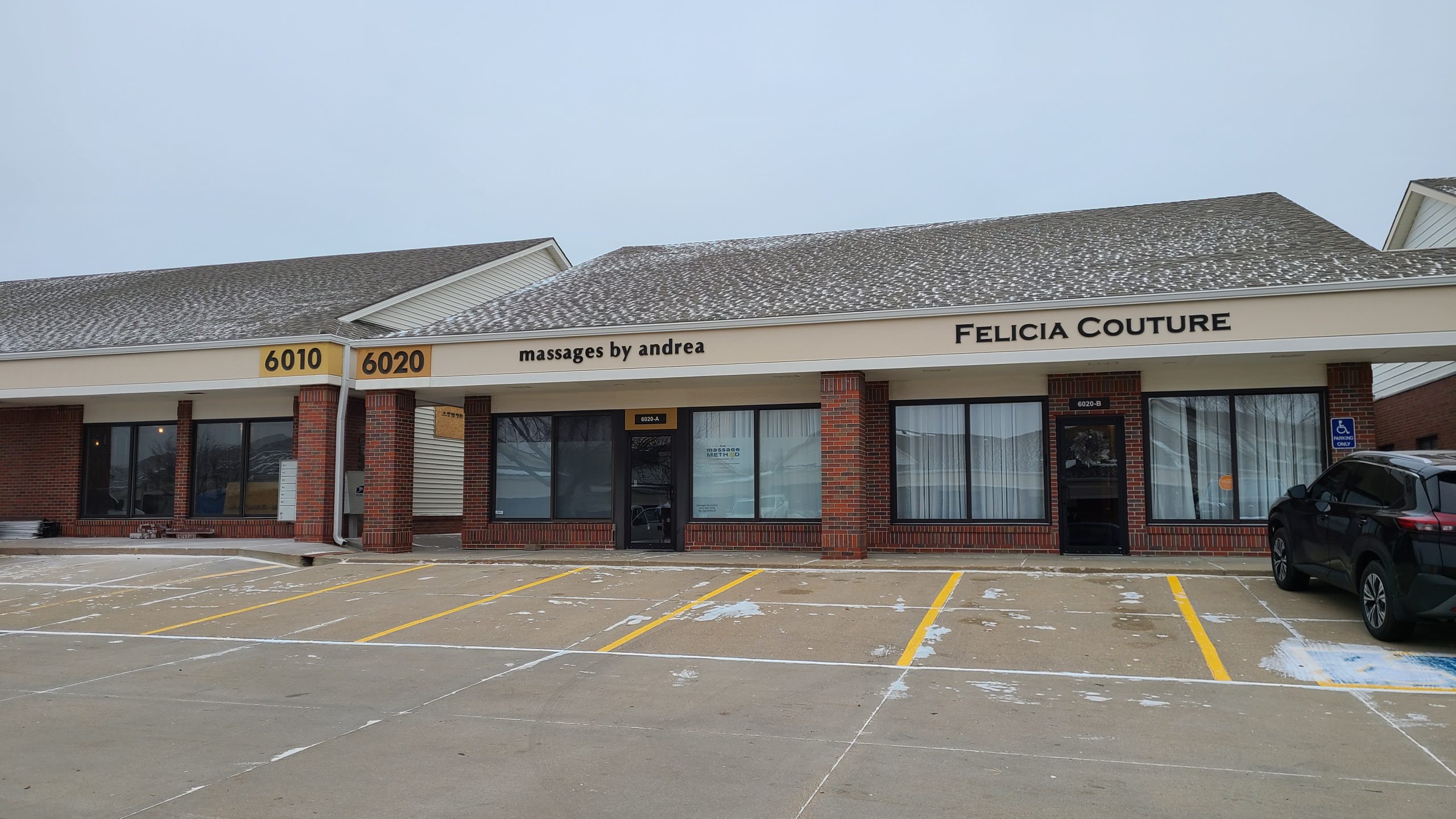 Front of the building at 6020 S. 58th St. with the Ben Stone Massage Therapy sign in the window